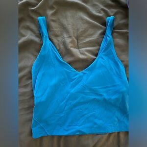 Two alighn tank tops one in blue and the other in purple they are each $25